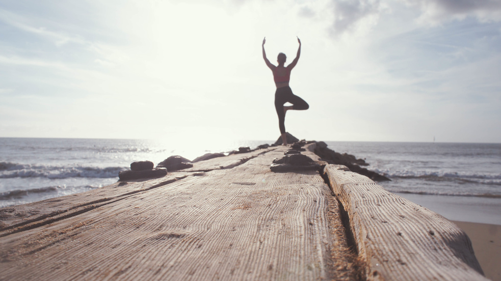 Man Doing Yoga by the Sea